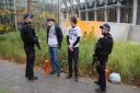 Just Stop Oil released video of two activists spraying the wall as well as pictures of two men being spoken to by police officers