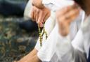 A worshipper holds pray beads ahead of the Eid prayer, which marks the end of Ramadan.