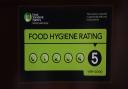 A Food Standards Agency rating sticker on a window of a restaurant in central London.