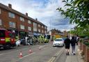 Emergency responders surrounded the car which had turned onto its side