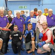 President of the Rotary Club of Huntingdon Cromwell, Geoff Richardson, presents the cheque to Mick Taylor, head coach at CAMPOL