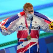 Great Britain's Tom Dean with his gold medal after winning the men's 200m freestyle on the fourth day of the Tokyo 2020 Olympic Games. Catch more of the action at Summer Screens this weekend in Canary Wharf.