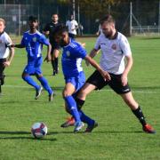 A Sporting Bengal United player looks to keep the ball from a Hoddesdon Town rival (pic: Tim Edwards).