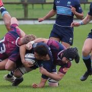 Eton Manor centre Aaron Lowe is tackled