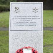 Members of the Ilford 84 branch of the Parachute Regimental Association with their memorial in Coronation Gardens, Romford