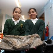 Shaheera Uddin, 10, and Muntaha Waqar, 10, from Highlands Primary School with a clay and wire trench created to mark the centenary of the First World War