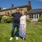 Eliza Yahioglu (right) and her husband Gokhan outside their new home