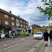 Emergency responders surrounded the car which had turned onto its side