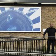 Mister Geez with his newest piece, 'Ilford Son' behind the Redbridge Town Hall.