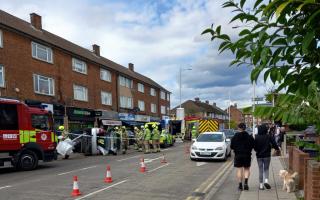 Emergency responders surrounded the car which had turned onto its side