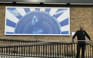 Mister Geez with his newest piece, 'Ilford Son' behind the Redbridge Town Hall.